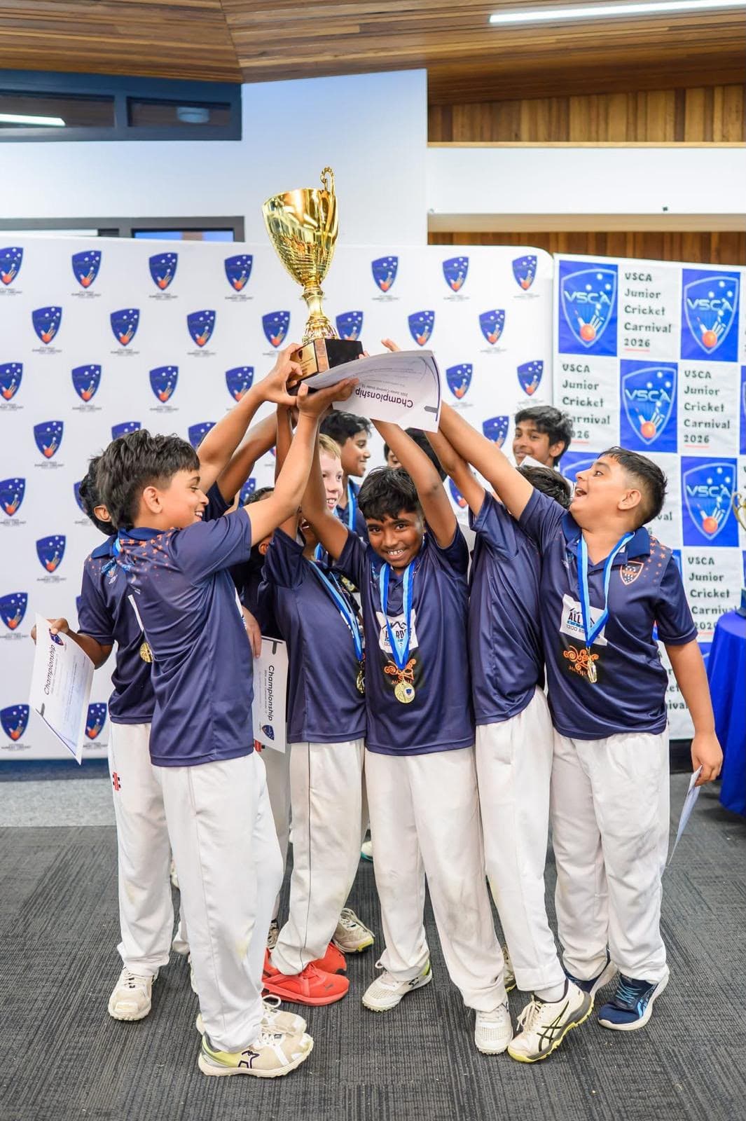 Melbourne Titans junior team celebrating with medals